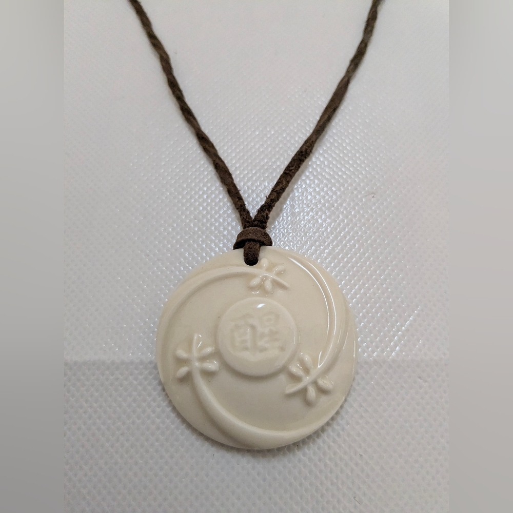 Cream Round Hawaiian Floral Pendant Necklace on Brown Cord